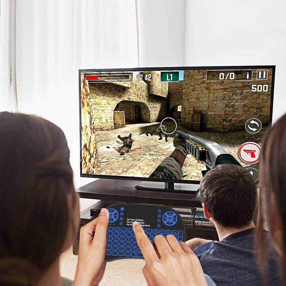 Compact keyboard for travel used to play video games on a large TV screen in a cozy living room