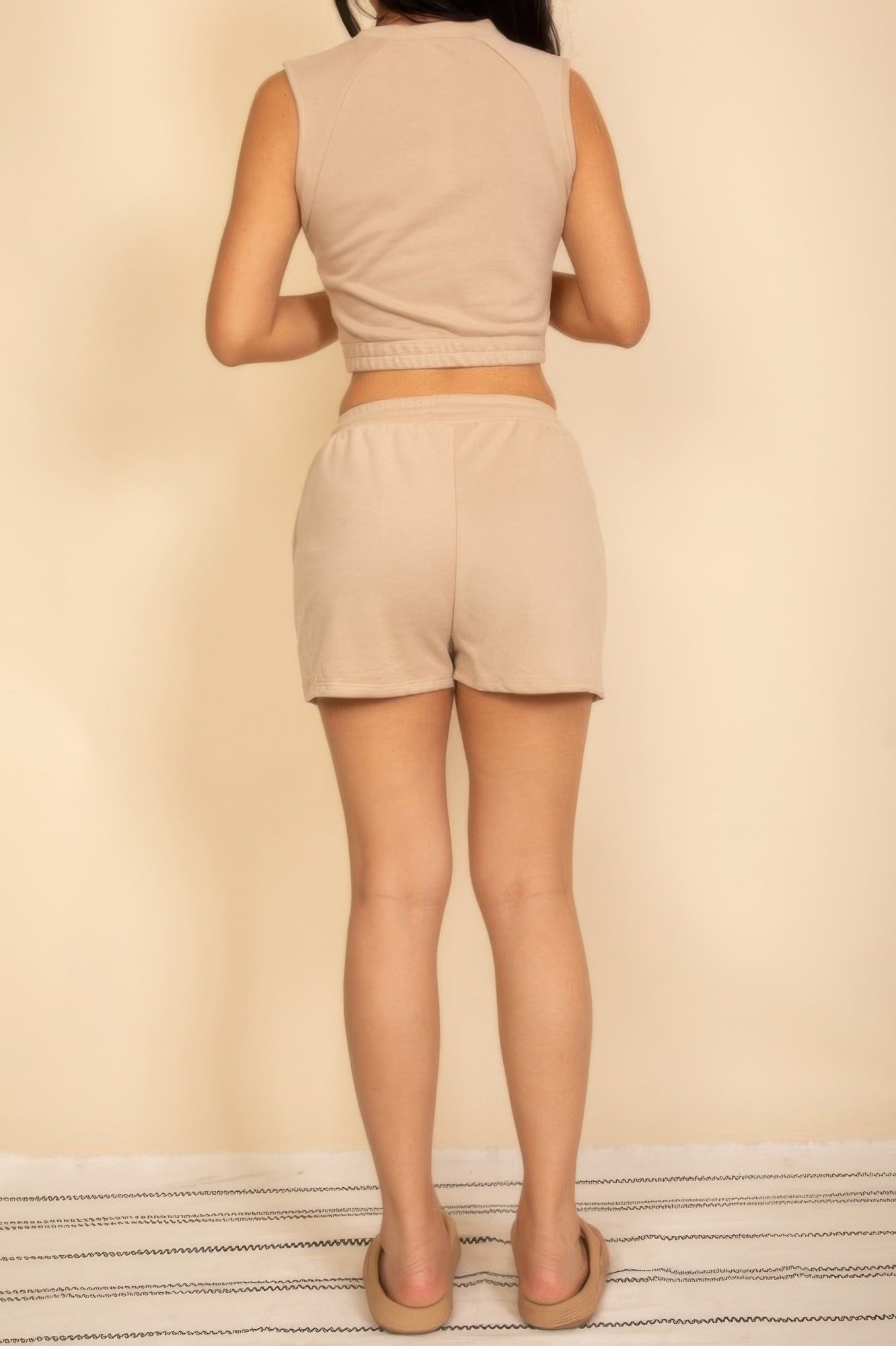 Back view of women's cotton French terry crop top and shorts set in beige, perfect for casual summer outings