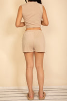 Back view of women's cotton French terry crop top and shorts set in beige, perfect for casual summer outings