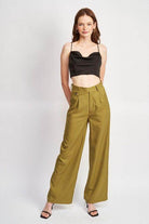 Emory Park black cowl neck satin bustier online paired with high-waisted olive green trousers