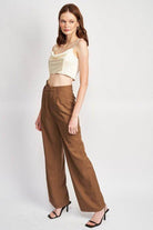 Emory Park cowl neck satin bustier online paired with high-waisted brown wide-leg pants for a stylish look