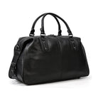 Stylish black cowskin leather travel bag with durable handles and spacious interior