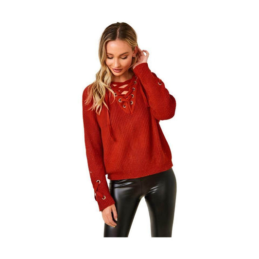 Women in a cozy knit lace-up sweater in red with lace-up detailing and ribbed texture