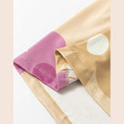 Close-up of a light fabric featuring a daisy print tank dress by SHEWIN INC