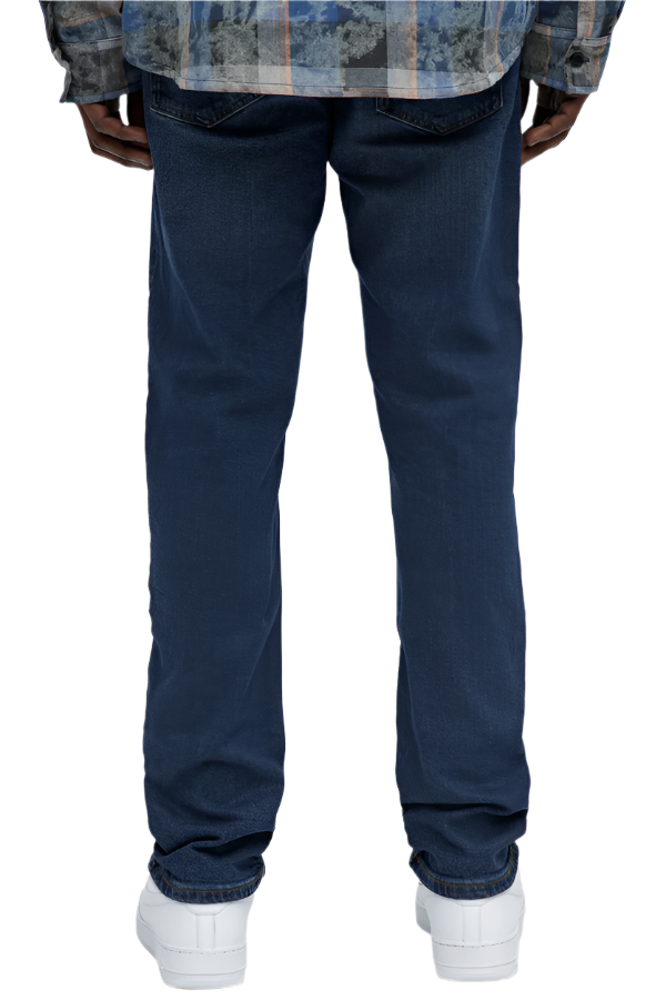 Dark wash urban jeans men by VacationGrabs shown from the back on a model wearing white sneakers