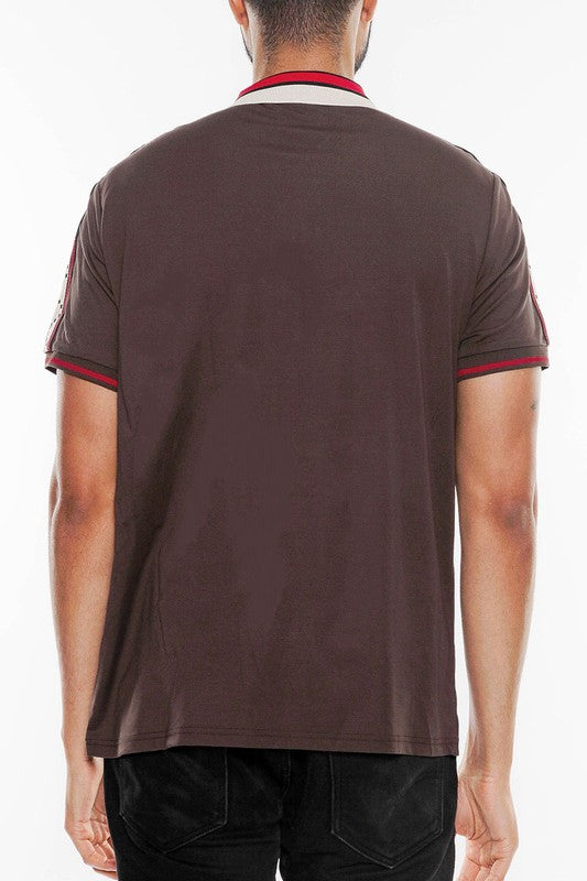 Back view of a man wearing a designer brown polo shirt by WEIV with red and beige collar details