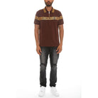 WEIV designer polo button down shirt in brown with gold Greek key pattern worn with black jeans and white sneakers