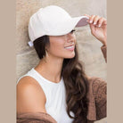 Aili's Corner designer velour caps in soft pink worn by a woman with long hair and hoop earrings