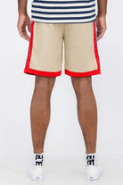 Back view of Double O Tape casual sweat shorts in beige with red side and bottom trim worn by a male model
