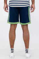 Back view of man wearing Double O Tape casual sweat shorts in navy with green accents