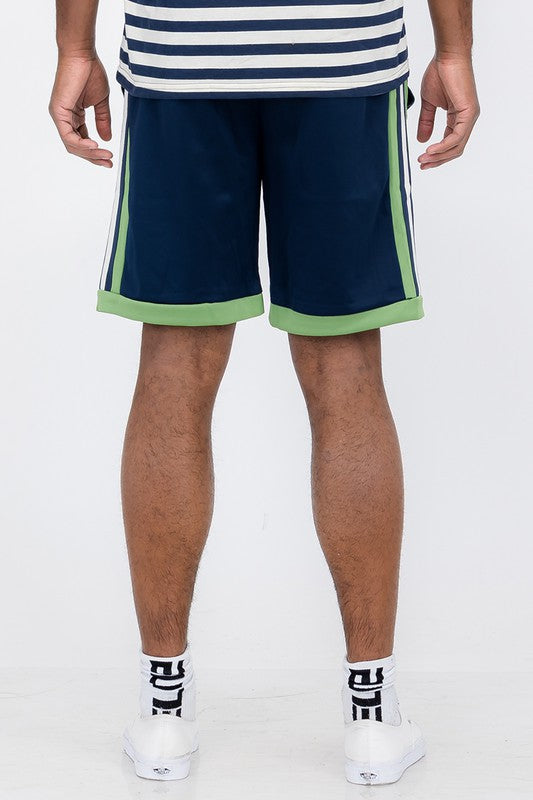 Back view of man wearing Double O Tape casual sweat shorts in navy with green accents