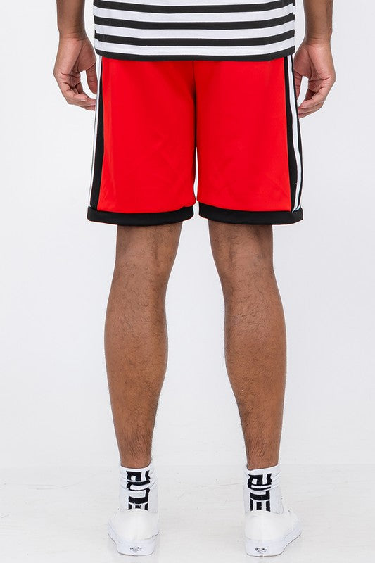 Back view of red Double O Tape casual sweat shorts with black and white stripes worn by model
