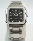 Silver watch with black dial on a white background
