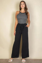 VacationGrabs women wearing black drawstring waist wide leg pants paired with striped tank top