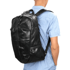 Durable travel backpack for men made of sleek black leather with adjustable straps