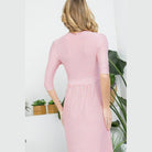 Back view of a dusty pink maxi dress with vertical stripes and three-quarter sleeves