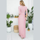 Back view of a dusty pink maxi dress by e Luna featuring a ribbed design and elegant silhouette