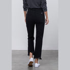 Back view of Insane Gene edgy straight leg jeans in black with frayed hem
