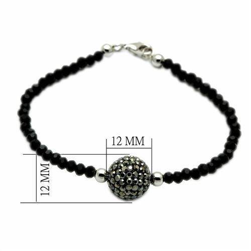 Elegant brass bracelet for vacation outfits featuring black beads and a sparkling focal bead