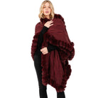 VacationGrabs long burgundy knit faux fur trim cape for women worn over black outfit