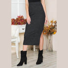 Elegant slit skirt in dark gray fabric paired with black ankle boots, perfect for chic occasions