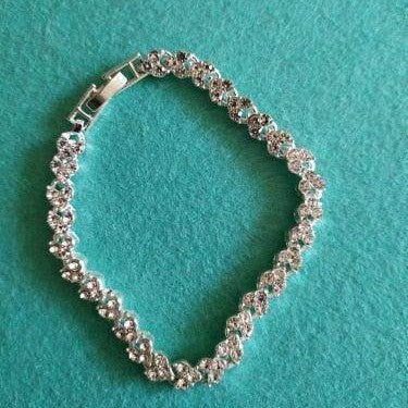 Elegant vacation jewelry bracelet with sparkling stones on a turquoise background