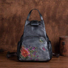 Stylish embossed leather travel bag with floral embroidery and adjustable straps for versatile use