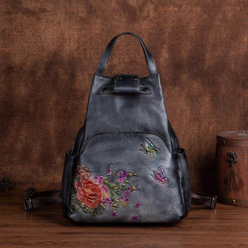 Stylish embossed leather travel bag with floral embroidery and adjustable straps for versatile use