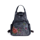 Embossed leather travel bag with floral design and colorful butterfly accents for stylish journeys