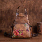 Stylish embossed leather travel bag with floral design and butterfly accents for fashionable travelers