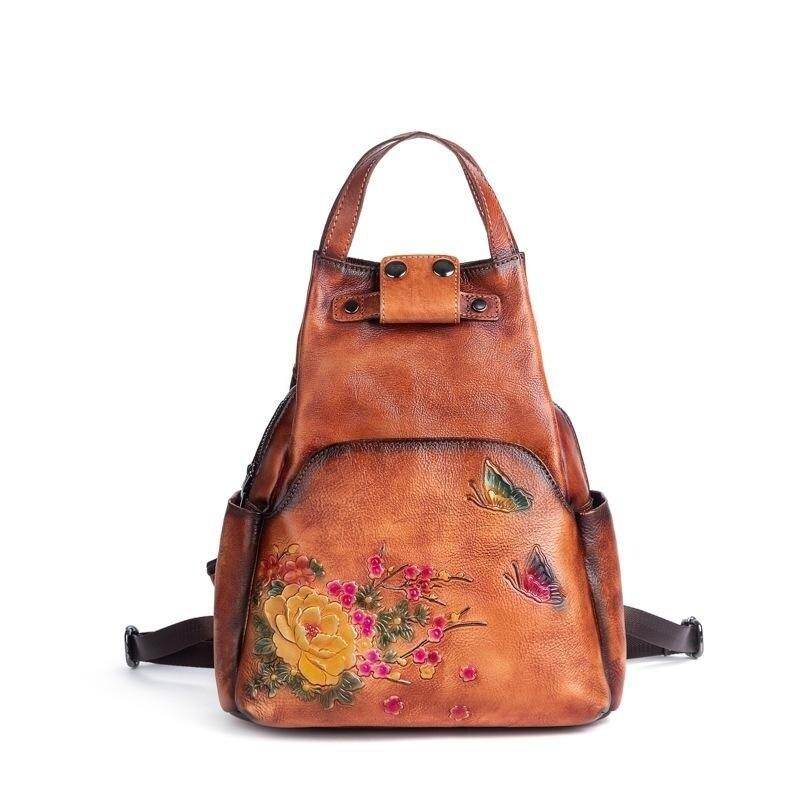 VacationGrabs embossed leather travel bag with floral design and butterfly accents for stylish adventures