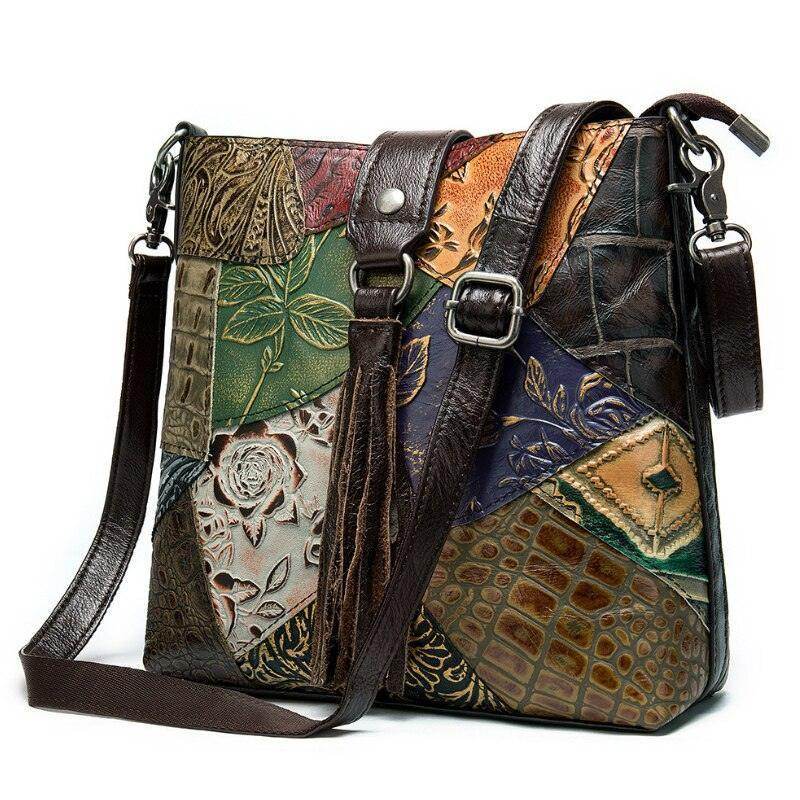 Colorful ethnic patchwork handbag with intricate designs and adjustable shoulder strap