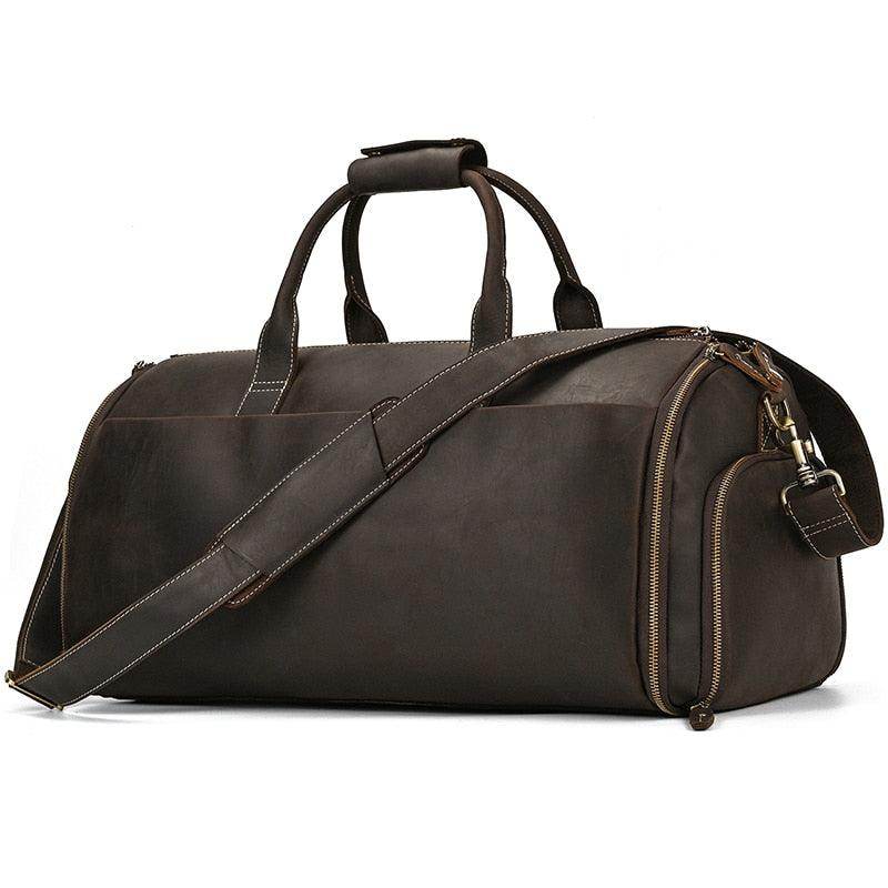 Foldable leather suit bag in dark brown with sturdy handles and adjustable shoulder strap for travel
