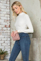 Andante USA Women's form-fitting travel bodysuit in white, stylishly paired with denim jeans