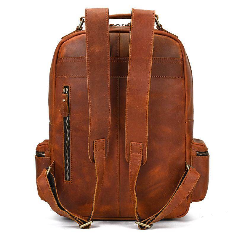 Genuine leather laptop backpack in brown with padded straps and multiple pockets for convenience