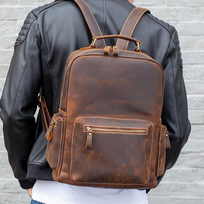 Genuine leather laptop backpack in brown, ideal for stylish travel and daily use.