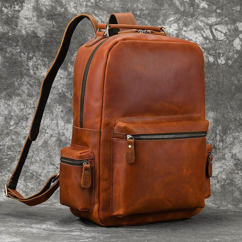 Genuine leather laptop backpack in rich brown with multiple zippered pockets for organization
