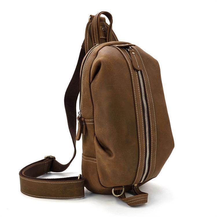 Genuine leather mens chest bag in brown with adjustable strap and zippered pockets for stylish convenience