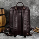 Genuine leather mens daypack in dark brown with sturdy shoulder straps and minimalist design
