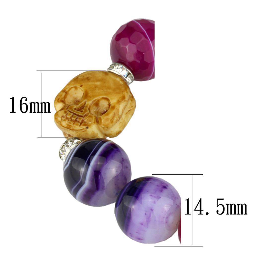 Colorful women's bracelet featuring a gold rhodium brass bracelet with gemstone accents and detailed skull charm