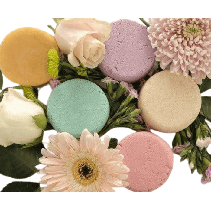 BeNat handcrafted shampoo bar assortment with pastel colors surrounded by fresh flowers