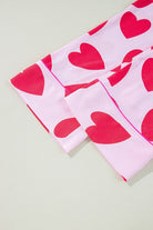 Close-up of pink heart print valentine pajamas set sleeves showing red heart pattern and cuff details