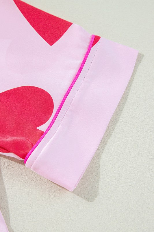 Close-up of YNIQUE heart print valentine pajamas set sleeve with pink and red heart design