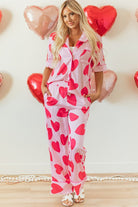 YNIQUE heart print valentine pajamas set with pink fabric and red hearts worn by a woman with long blonde hair
