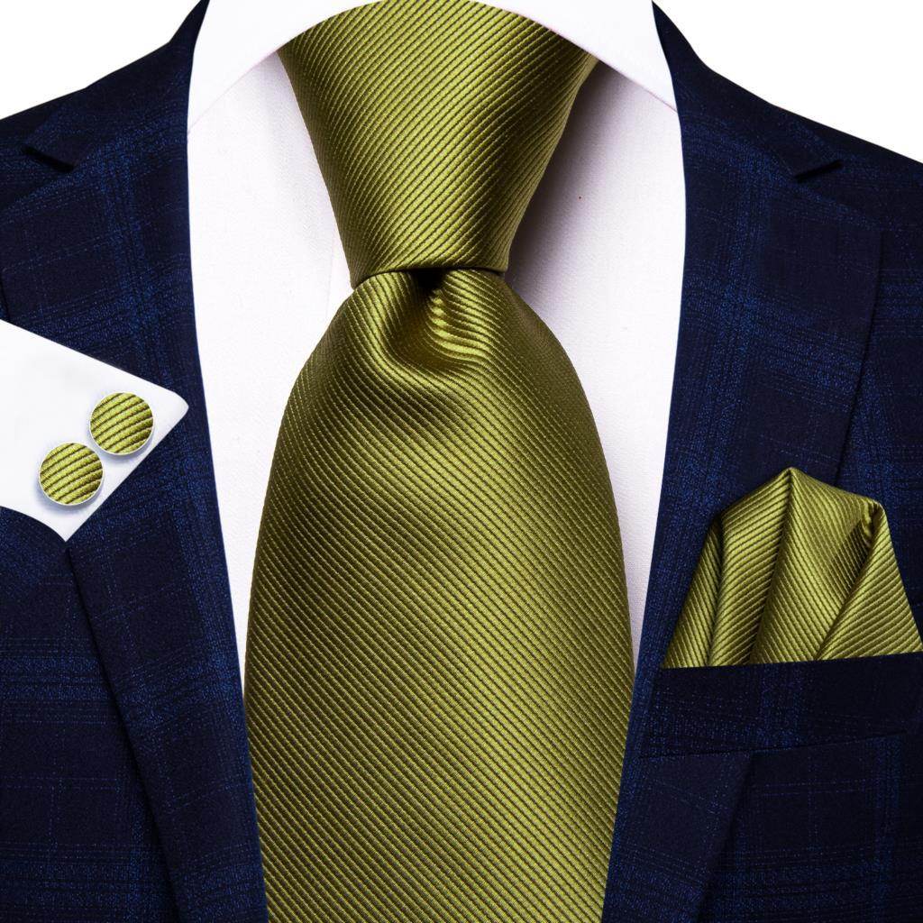 Gold paisley formal tie elegantly paired with a navy suit and matching pocket square