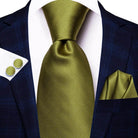 Gold paisley formal tie elegantly paired with a navy suit and matching pocket square