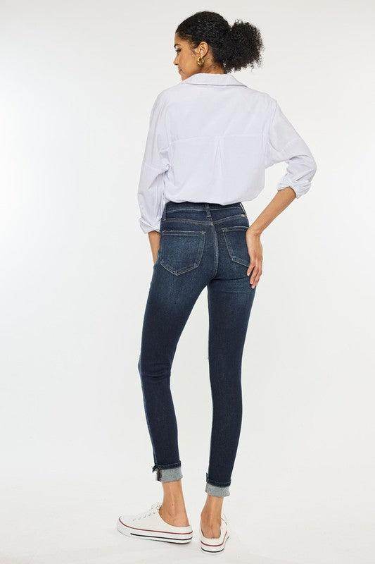Back view of women wearing Kan Can USA high rise skinny jeans for women with a white shirt and casual shoes