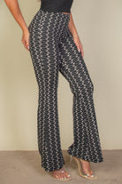 VacationGrabs black and white patterned high waist bell bottoms for women styled with clear heeled sandals