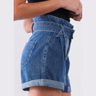 Tasha Apparel high waisted mom shorts in light denim with rolled hems and a tie waist detail