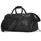 Elegant black hot leather carry-on bag with intricate floral design and adjustable shoulder strap